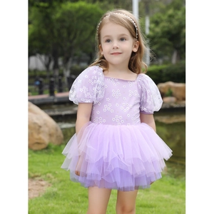 Close-up of purple ballet dress featuring floral print bodice and sheer puff sleeves