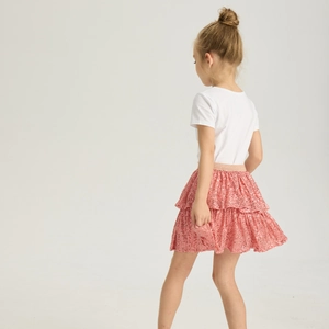 Close-up of girls pink sequined tutu skirt with layered ruffles and golden elastic waist