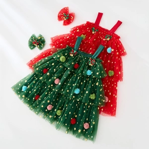 Detail of Christmas tutu dress showing star sequins, colorful pom poms and bell accents