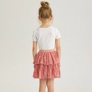 Detail of pink sequin tiered tutu skirt with a gold elastic waistband and white shirt