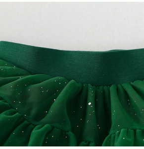 Détail macro du tutu vert émeraude montrant la taille élastique et le tulle pailleté argenté
