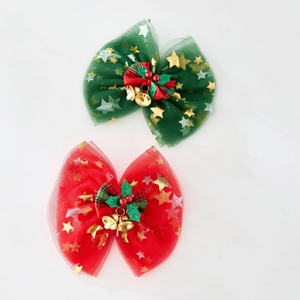Detail of Christmas tutu dress hair bows with gold stars and festive bells