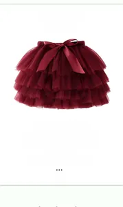 Detail of multi-layer mesh tutu skirt in dark red with a satin bow and built-in diaper cover