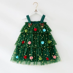 Detail of dark green toddler tutu dress with golden stars and colorful pom-poms
