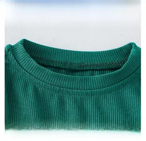 Detail of round neckline on green rib-knit princess dress with high elastic fabric