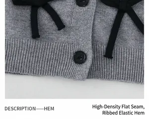 Gros plan d'un cardigan gris en maille avec ourlet côtelé et détail de nœud noir