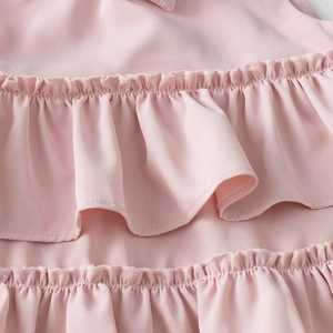 Detail of pink tiered ruffles with layered chiffon fabric on girls' party dress
