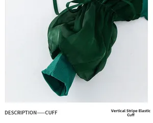 Close-up of girls' dark green puff sleeve dress featuring ribbed elastic cuffs and ruffles