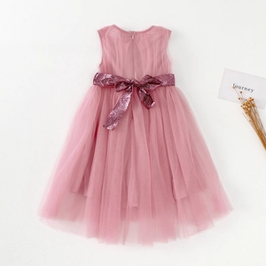 Detail of pink tulle flower girl dress showing a sparkling sequin bow and layered skirt