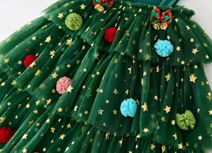 Detail of Christmas tutu dress with gold stars, pom poms and festive checkered bow