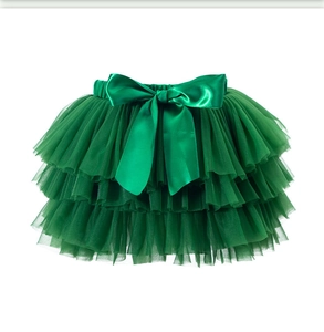 Close-up of fluffy green multi-layer tulle tutu skirt with a large satin bow detail