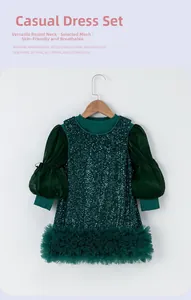 Close-up of green girl's dress showing mesh puff sleeves and sparkling sequins texture