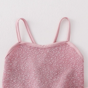 Detail of pink sparkly girls' gymnastics leotard with sequins and thin shoulder straps