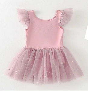 Close-up of pink ballet dress with sparkling star patterns and ruffled sleeves