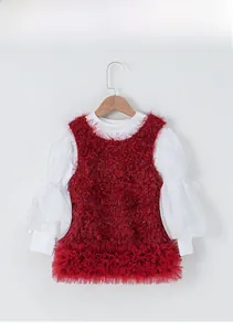 Detail of red plush vest layered over white puff sleeve dress with tulle ruffle skirt