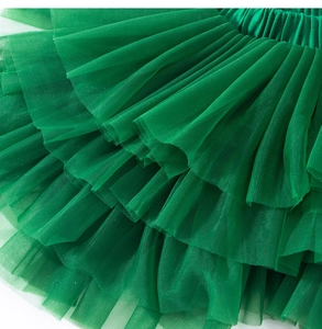 Detail of emerald green multi-layer tulle tutu dress with ruffled mesh and elastic waistband