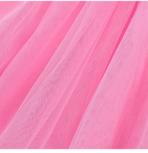 Detailed macro shot of multi-layer bright pink tulle fabric with fine mesh texture