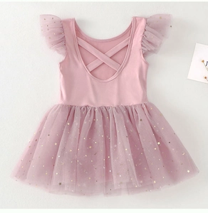 Detail of pink girls ballet dress featuring glittering gold star and moon sequins on tulle