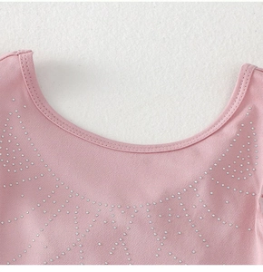 Close-up of pink gymnastics leotard neckline with sparkling silver rhinestone detailing