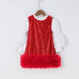 Detail of girls sparkling red sequin bodice with plush feather hem and white puff sleeves