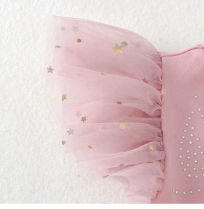 Detail of pink ballet tutu sleeves with gold stars and sparkling rhinestone accents