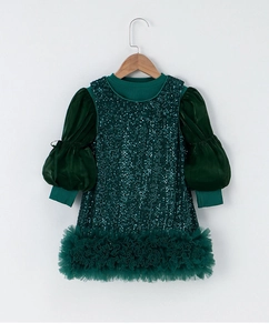 Detail of girls dark green sequin dress with puffy lantern sleeves and tulle hem