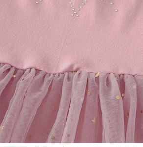 Detailed view of pink ballerina dress with rhinestone stars and gold foil moon tulle