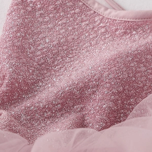 Detail of pink glitter fabric and soft tulle layers on children's ballet dress