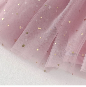 Detailed macro view of pink tulle fabric with gold foil stars and moon patterns