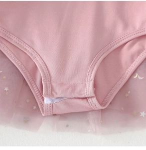 Close-up of pink baby tutu romper showing snap crotch and gold star sequin mesh skirt