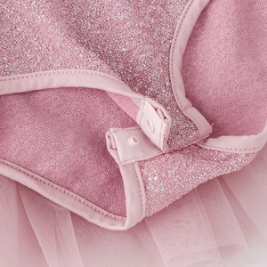 Detail of pink girls ballet leotard with silver sequins and snap crotch fasteners