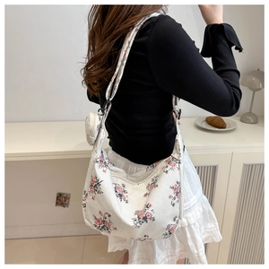 Detailed shot of floral hobo bag with matching coin purse on a soft fabric strap