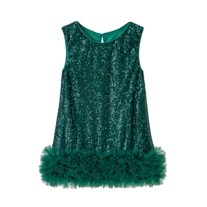 Close-up of emerald green sleeveless dress with shimmering sequins and layered mesh hem
