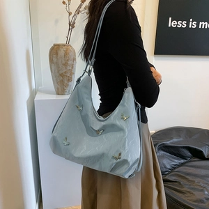 Light blue large hobo bag with silver butterfly charms and adjustable shoulder strap