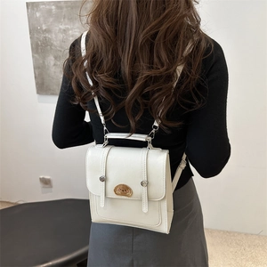 White mini faux leather backpack with cartoon patch and top handle for women