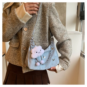 Light blue crescent shoulder bag with silver butterfly charm and plush cloud pendant detail