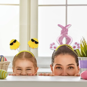 Detail of Easter headbands featuring yellow plush chicks and glitter bunny ears for parties