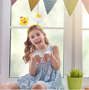 Detail of yellow Easter headband with plush chicks and eggshells for party decoration