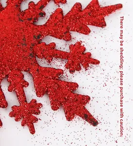 Close-up of red glitter snowflake topper with sparkling details for Christmas tree decor