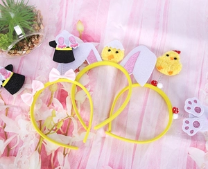 Detail of Easter felt headbands featuring cartoon chick and bunny ears for party decor