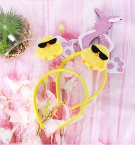 Detail of yellow Easter headbands with plush chicks in sunglasses and pink rabbit ears