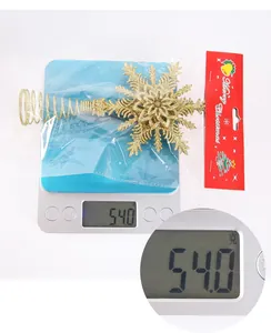 Golden glitter star tree topper weighing 54g in Merry Christmas themed packaging