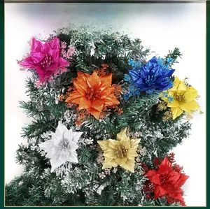 Close-up of glitter poinsettia flowers in seven colors on green Christmas tree branches