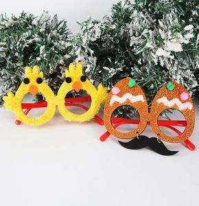 Detail of plush yellow chick and glittery egg glasses with fun mustache for Easter parties