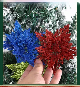 Close-up of glittered 13cm Christmas artificial flowers on a snowy tree for DIY decor