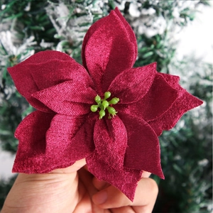 Macro detail of red velvet petals and green stamens on artificial Christmas flower