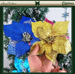 Detail of multi-colored glitter poinsettia flowers on Christmas tree decorations