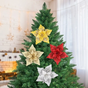 Close-up of sparkling 16cm glitter fabric poinsettia flowers on a green Christmas tree