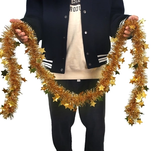 Golden 2m Christmas garland with star sequins held by a model for party decoration