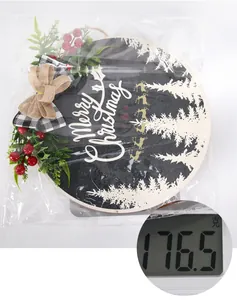 Close-up of a 28cm Christmas wooden door sign on a scale showing 176.5 grams weight